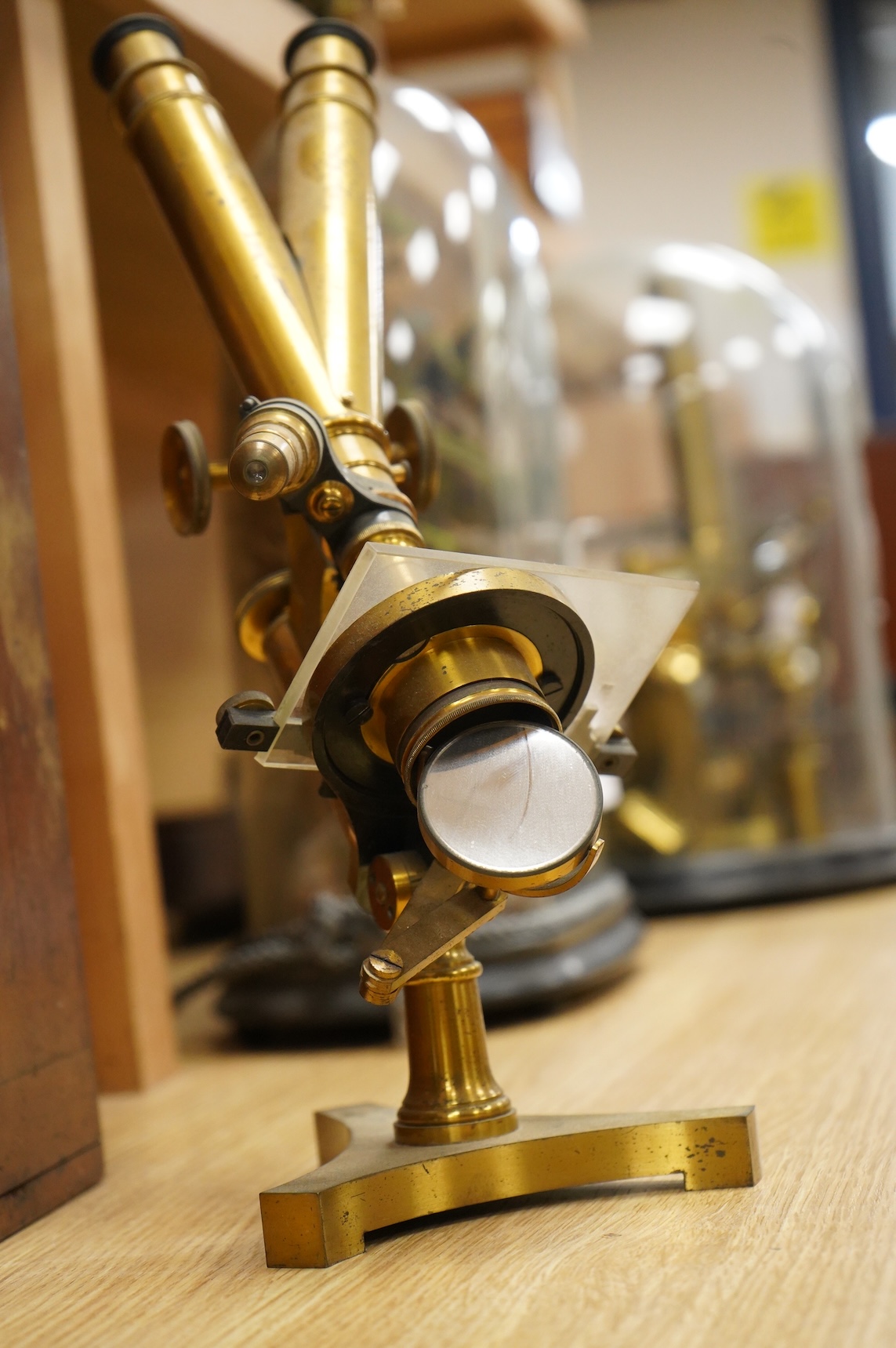 A late 19th century brass compound binocular microscope, by R. & J. Beck, London, number 13654, mahogany cased, together with accessories, including a pair of eye pieces and three objectives. Instrument height 39cm